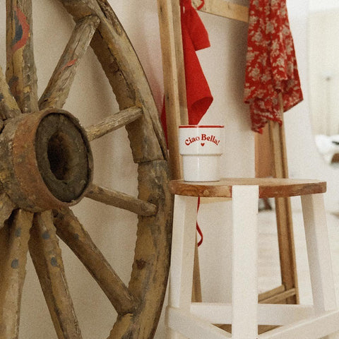 1. Terra Mamma 'Ciao Bella!' ceramic mug on rustic wooden chair with wagon wheel backdrop