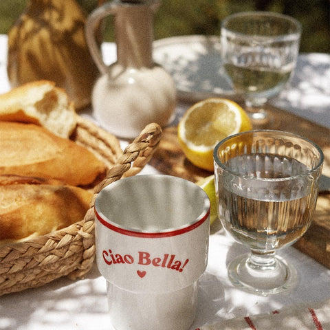 1. Terra Mamma 'Ciao Bella!' ceramic mug on outdoor table with bread, lemon, and glassware