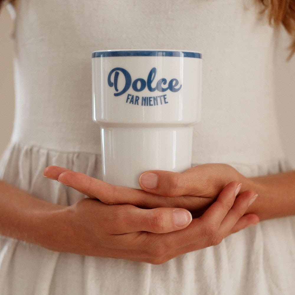 6. Close-up of hands holding Terra Mamma ceramic mug with 'Dolce far Niente' text in white dress
