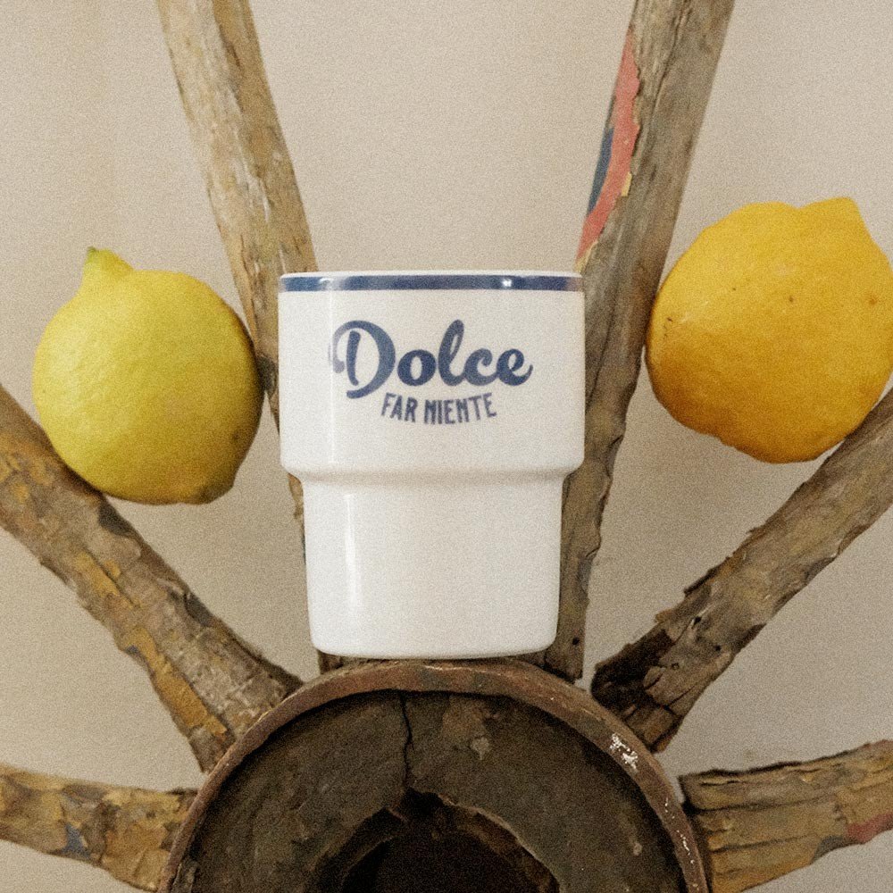 4. Terra Mamma ceramic mug with 'Dolce far Niente' text placed on rustic wooden structure with lemons