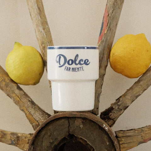 4. Terra Mamma ceramic mug with 'Dolce far Niente' text placed on rustic wooden structure with lemons
