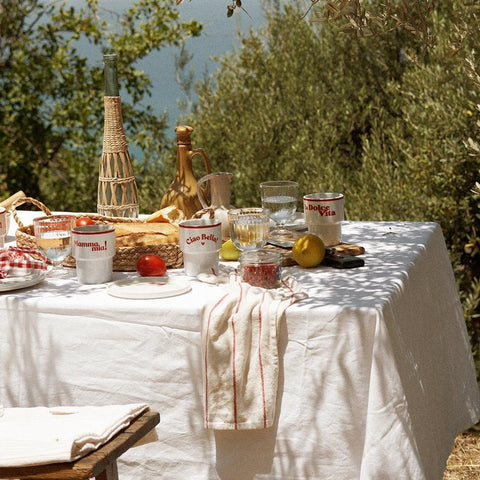 4. Terra Mamma 'La Dolce Vita' ceramic mug on outdoor dining table with various Italian-themed items