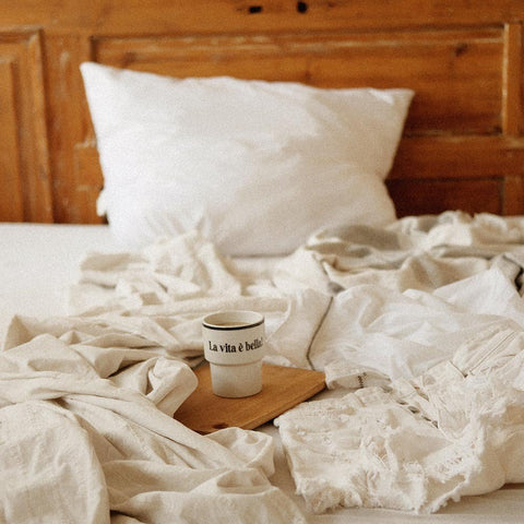 2. Terra Mamma ceramic mug with 'La vita è bella!' text on wooden tray in cozy bedroom setting