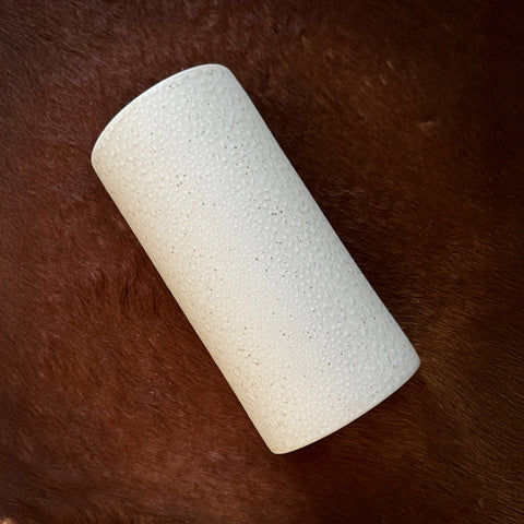 4. Flat lay of beige spotted brown ceramic wall sconce on dark textured surface