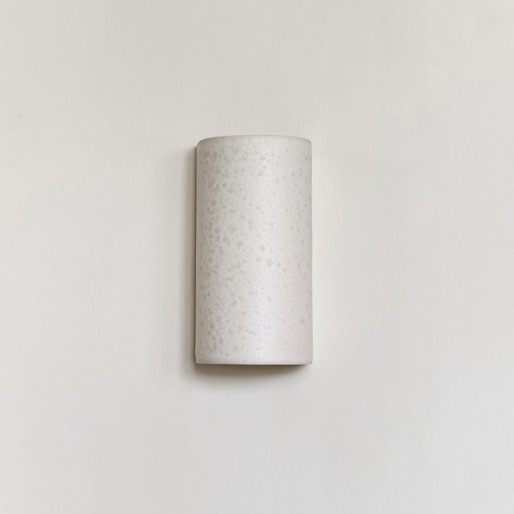 2. Studio shot of ceramic wall light in raw white on plain wall