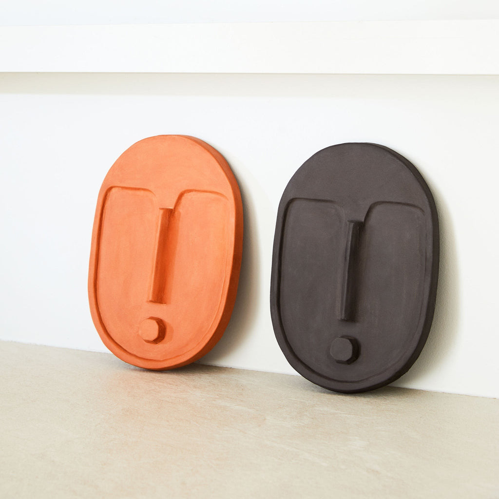 7. Terracotta orange and black ceramic wall masks by 5mm Paper displayed together
