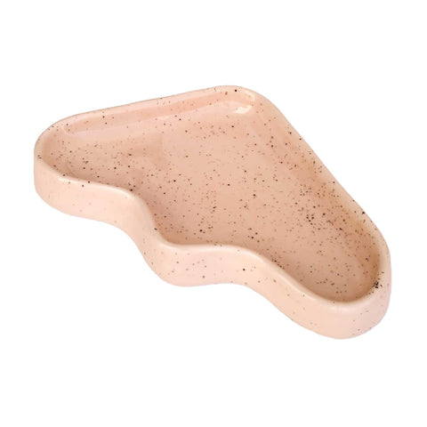 4. Studio shot of Ceramic Wave Tray in peach triangle design, highlighting unique shape and speckled finish