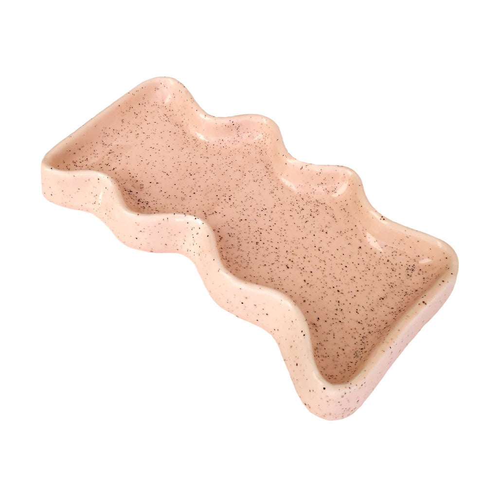 3. Studio shot of Ceramic Wave Tray in speckled peach, highlighting its wavy design and ceramic material