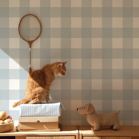 1. Light blue checkered wallpaper in a room with a cat sitting on boxes and a toy dog on a wooden cabinet, creating a cozy and playful atmosphere