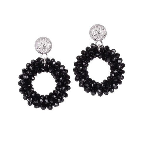 2. Studio shot of MyaMoon Cherie Boho L earrings in rose gold and silver with black spinel pearl rings on white background