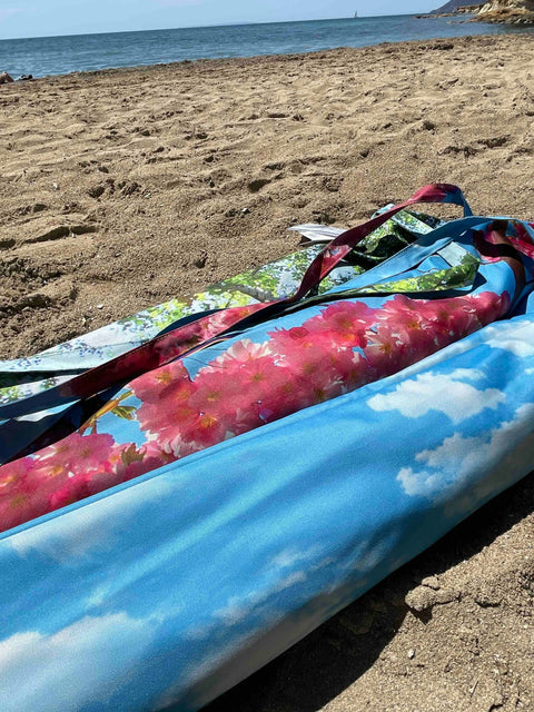 4. Flat lay of cherry beach and terrace parasol with floral and sky prints on sandy beach