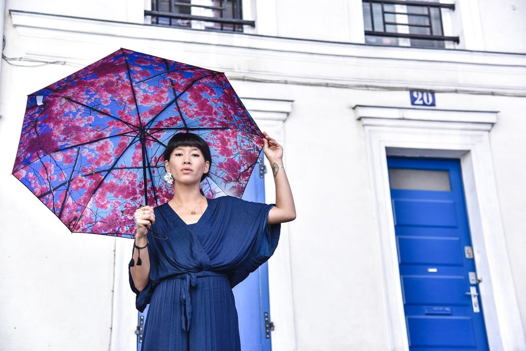 5. Woman holding Cherry Blossom umbrella with floral pattern in urban setting