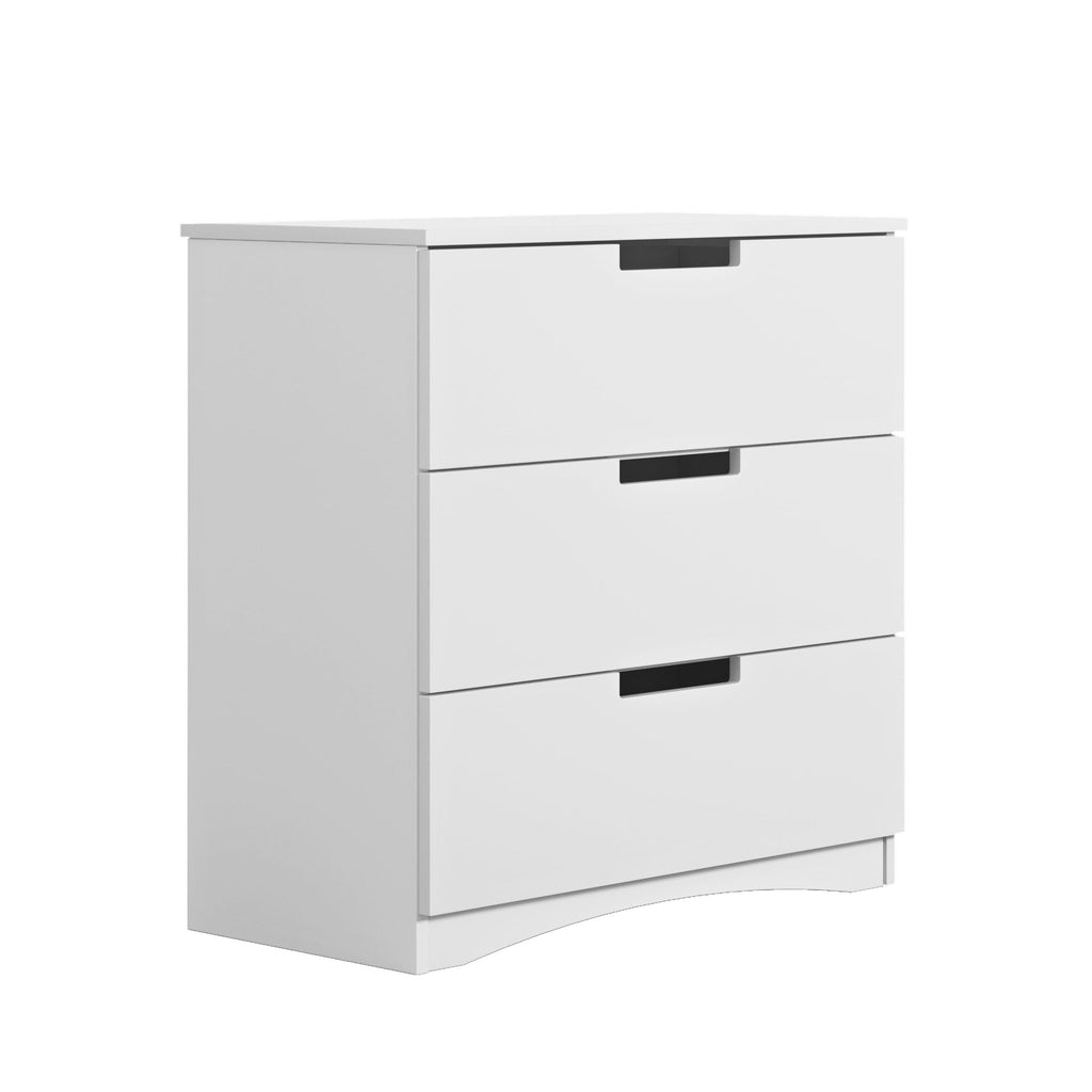 2. Angled view of white chest of drawers with three drawers and ergonomic cutouts in a studio setting