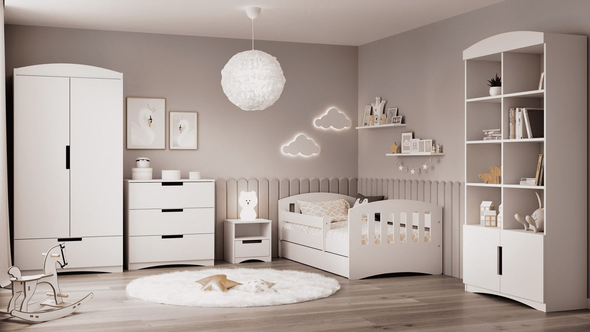 1. White chest of drawers in a child's room with matching furniture and decorative elements