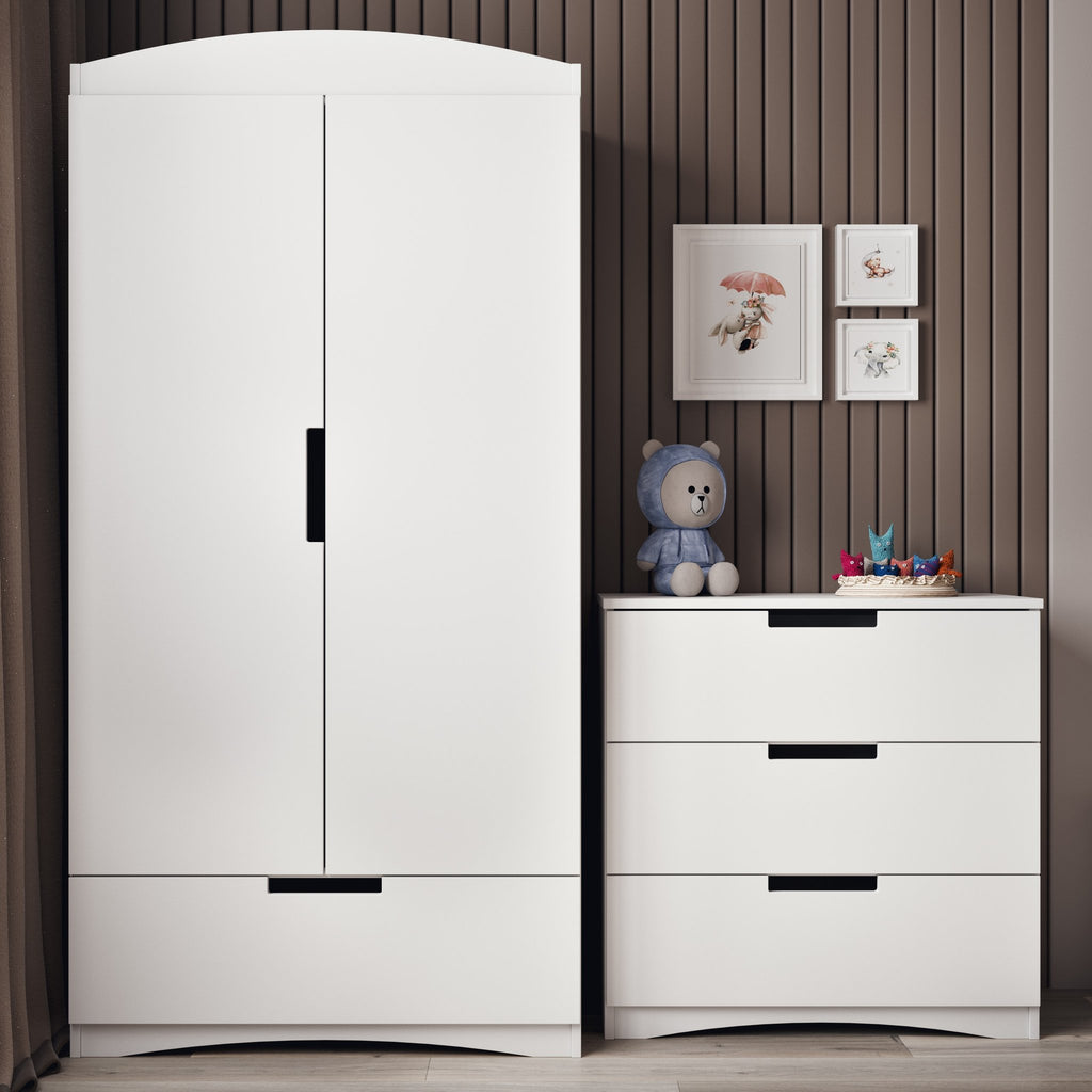 1. White chest of drawers and wardrobe in a child's room with teddy bear and framed pictures on the wall