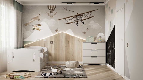 1. White chest of drawers in a child's room with airplane-themed wall decor and bed