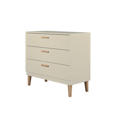 3. Angled studio view of Kocot Kids Kubi cashmere chest of drawers with oak handles and legs