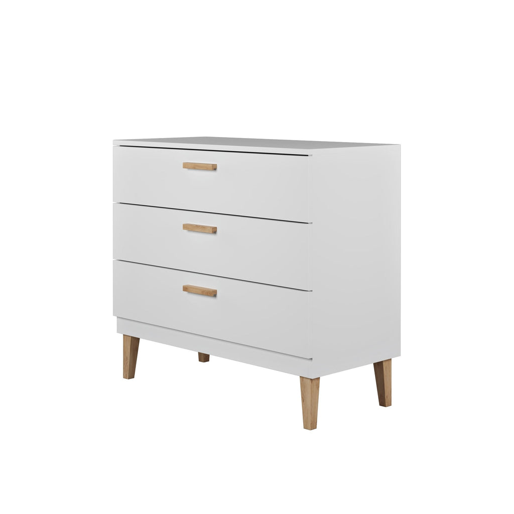 2. Side view of white chest of drawers with three oak-handled drawers and solid oak legs in a studio setting