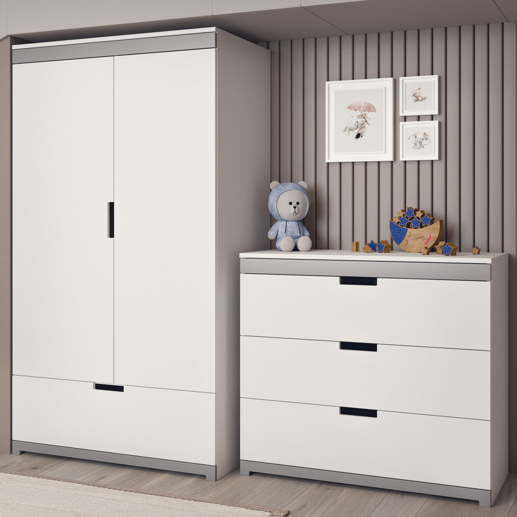 4. White chest of drawers with grey accents next to a matching wardrobe in a children's room, decorated with a teddy bear and framed art