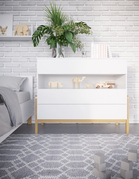 1. White chest of drawers with oak accents in children's room, decorated with plants and toys