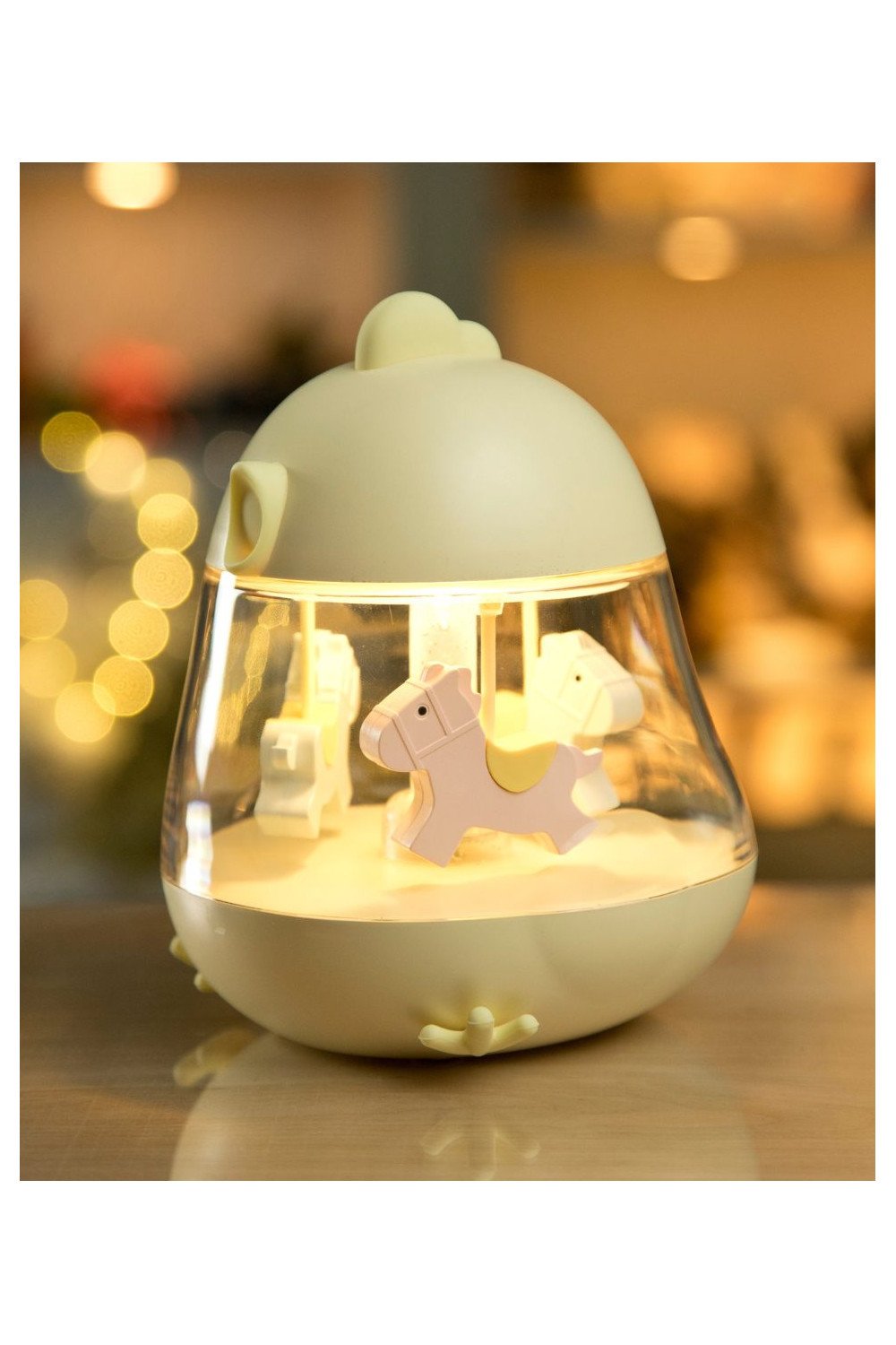 2. Yellow Rabbit & Friends lamp with carousel and music box illuminated on wooden surface, showing pink horse inside