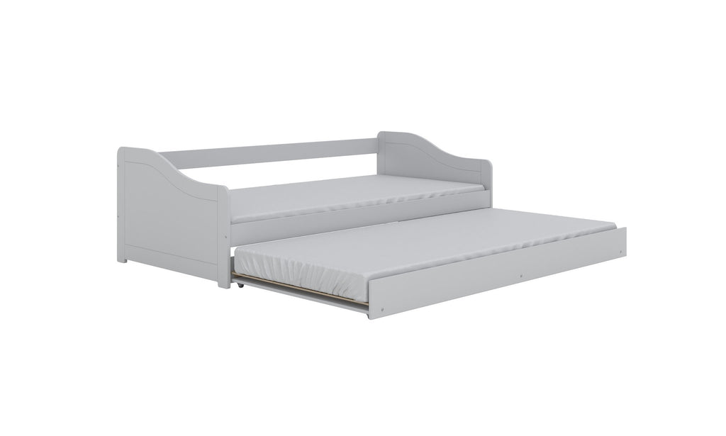 5. Children's white bed with pull-out trundle in studio setting