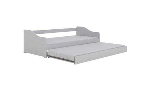 5. Children's white bed with pull-out trundle in studio setting