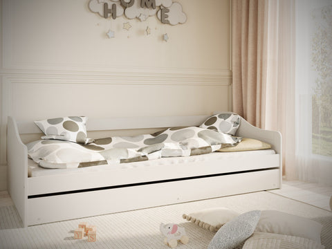 3. Children's white bed with polka dot bedding in a bright room with soft decor