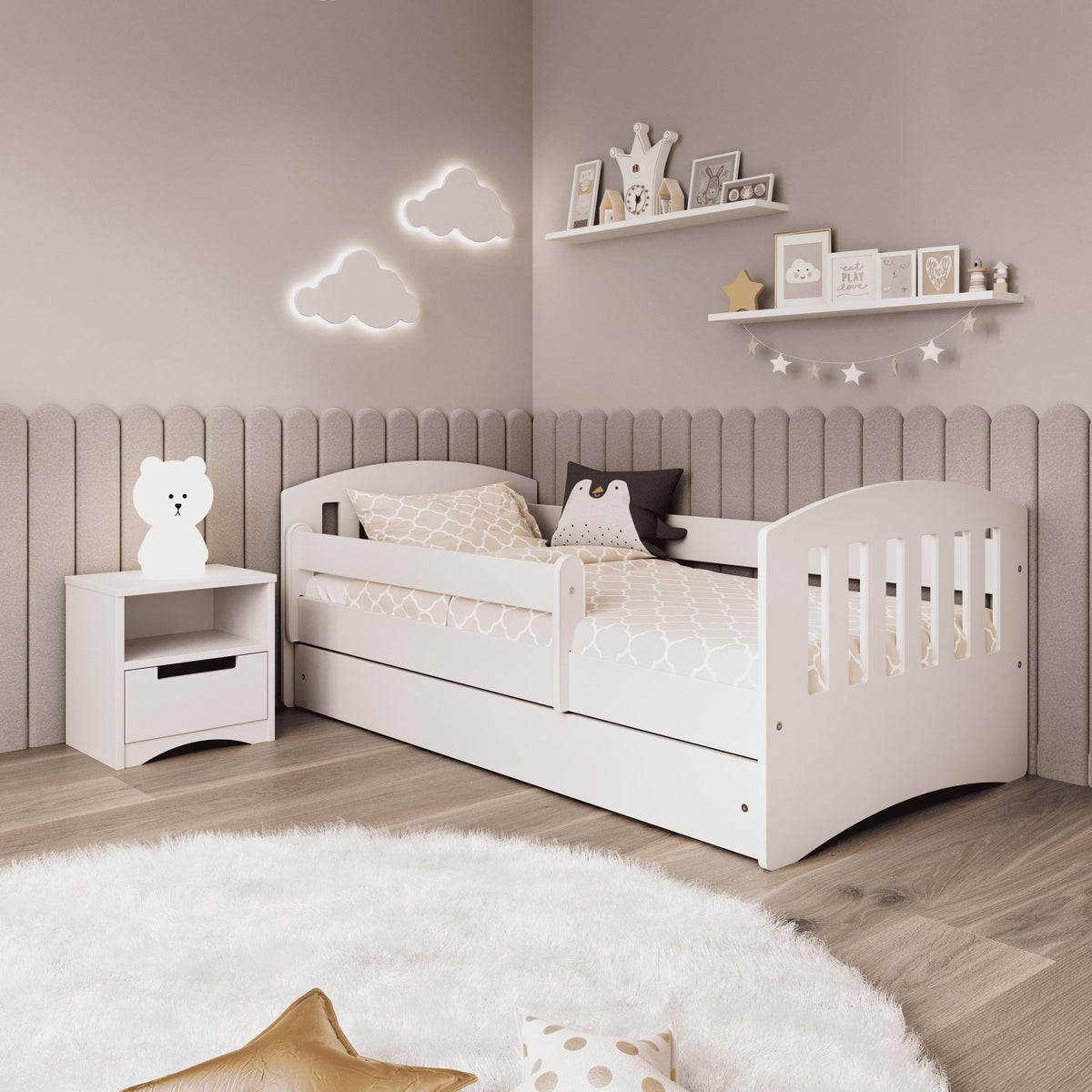 1. White children's bed with guardrail in cozy room with cloud wall decor and plush rug