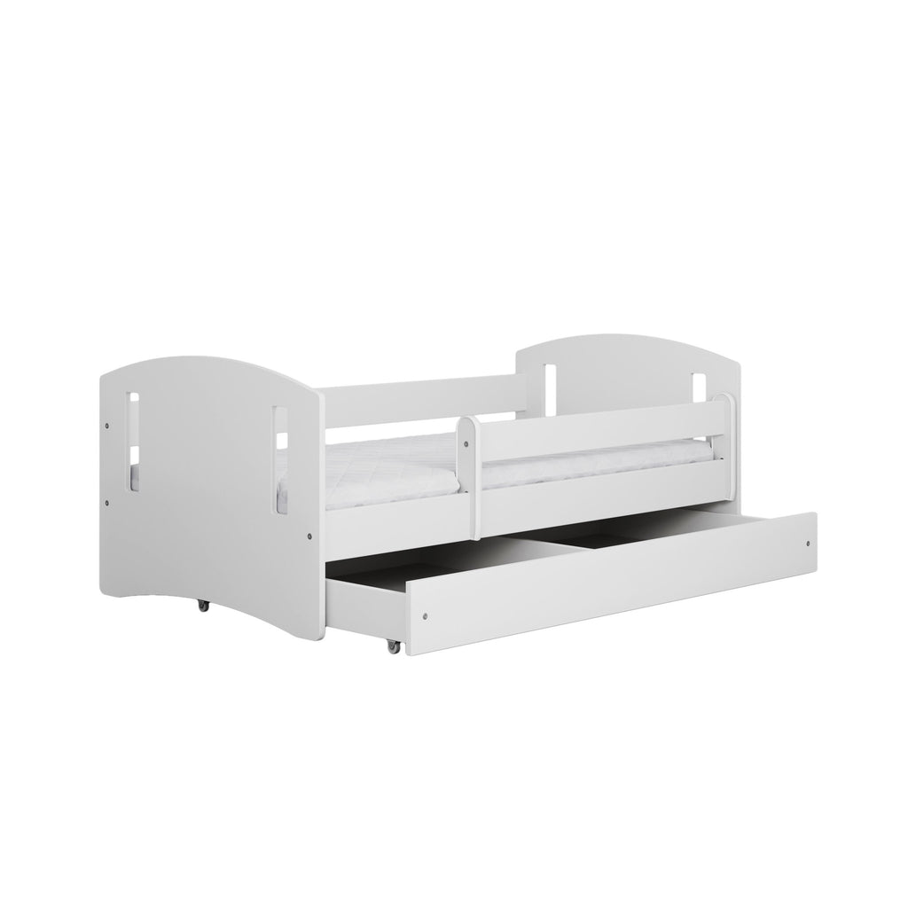 2. White children's bed with pull-out storage drawer and guardrail in studio setting