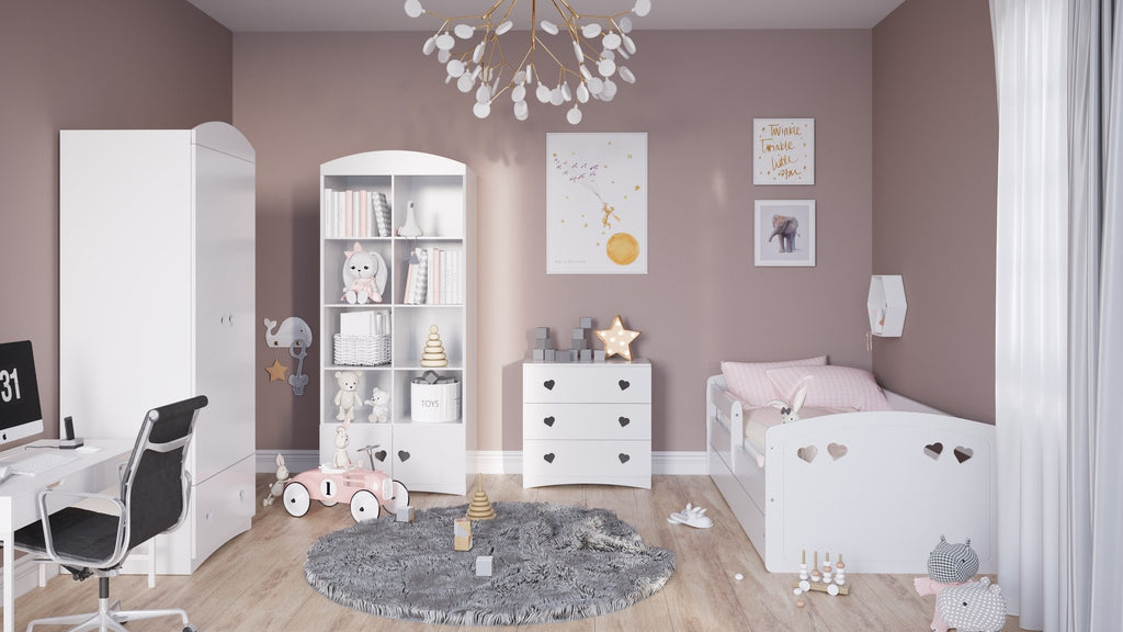 2. White children's bed with heart cutouts in a pink-themed room with matching furniture and decor