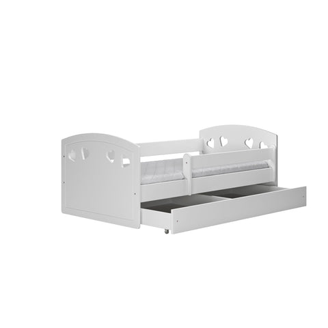5. Studio shot of white children's bed with heart cutouts and open storage drawer
