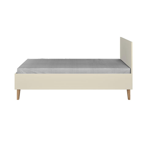 3. Side view of Kubi children's bed in cashmere with solid oak legs and grey mattress