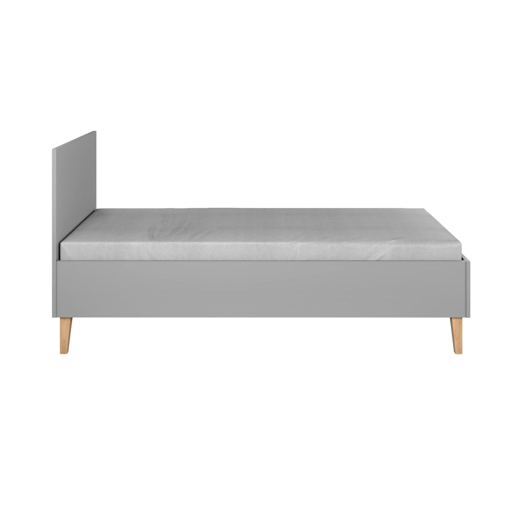 4. Grey children's bed with oak legs shown from side in a studio setting, emphasizing clean lines