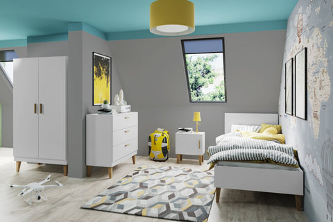 1. Modern children's bedroom with white Kubi bed, geometric rug, and matching furniture