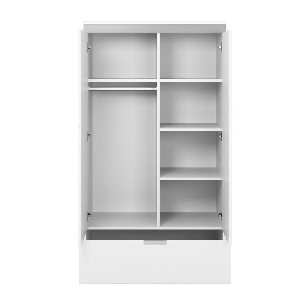 7. Interior view of Kocot Kids Tomi wardrobe showing shelves, clothing rail, and drawer in white