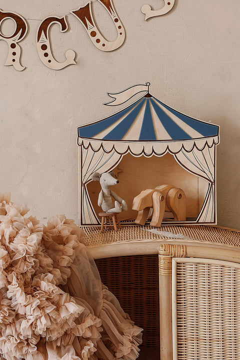 1. Children's room with blue and white circus puppet theater decoration on wicker cabinet, featuring plush toys inside, enhancing vintage charm