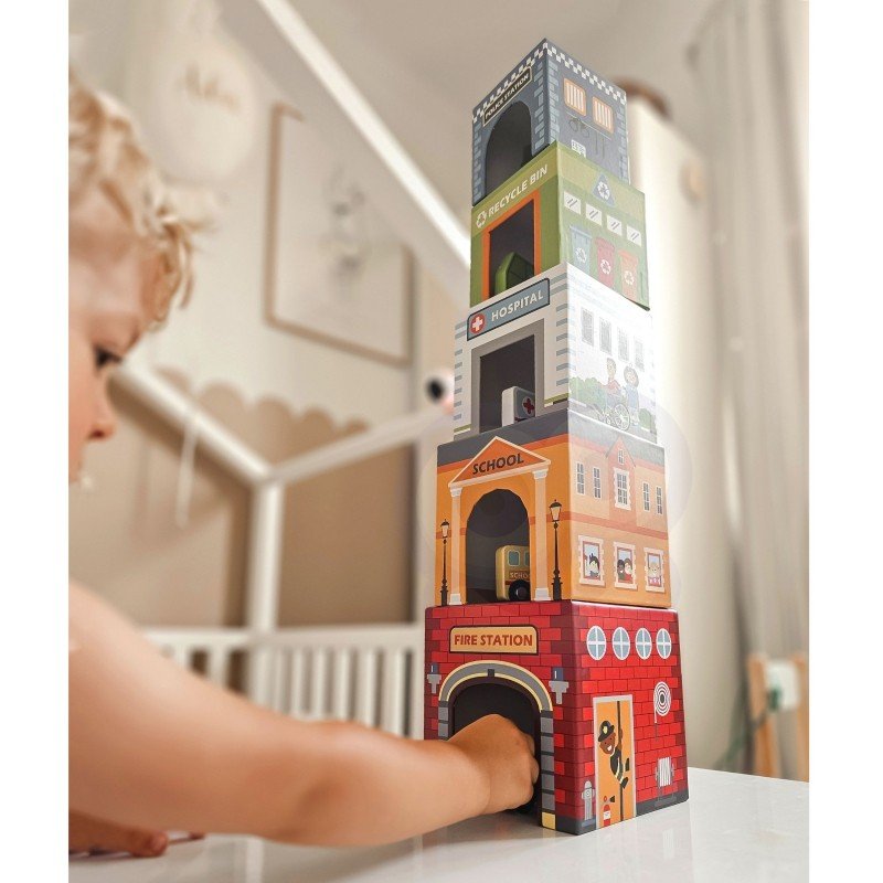 6. Child stacking colorful city-themed puzzle cubes in a tower in a playroom