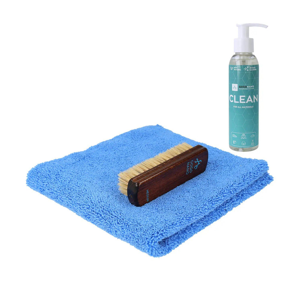 1. GoGoNano cleaning kit with blue microfiber cloth, natural hoghair brush, and cleaning agent bottle on white background