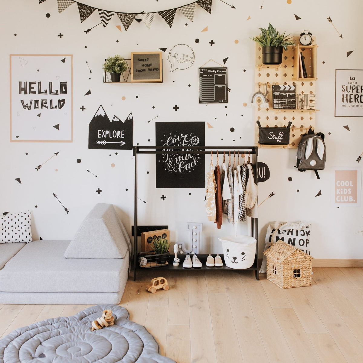 5. Black toddler clothing rack in a decorated children's room with clothes and toys