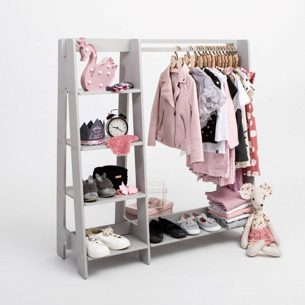 9. Grey clothing rack with pink toddler clothes and toys on white background