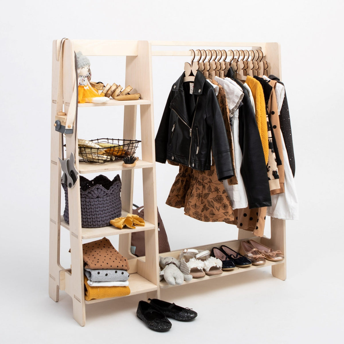 11. Natural wood clothing rack with toddler clothes and shoes on white background