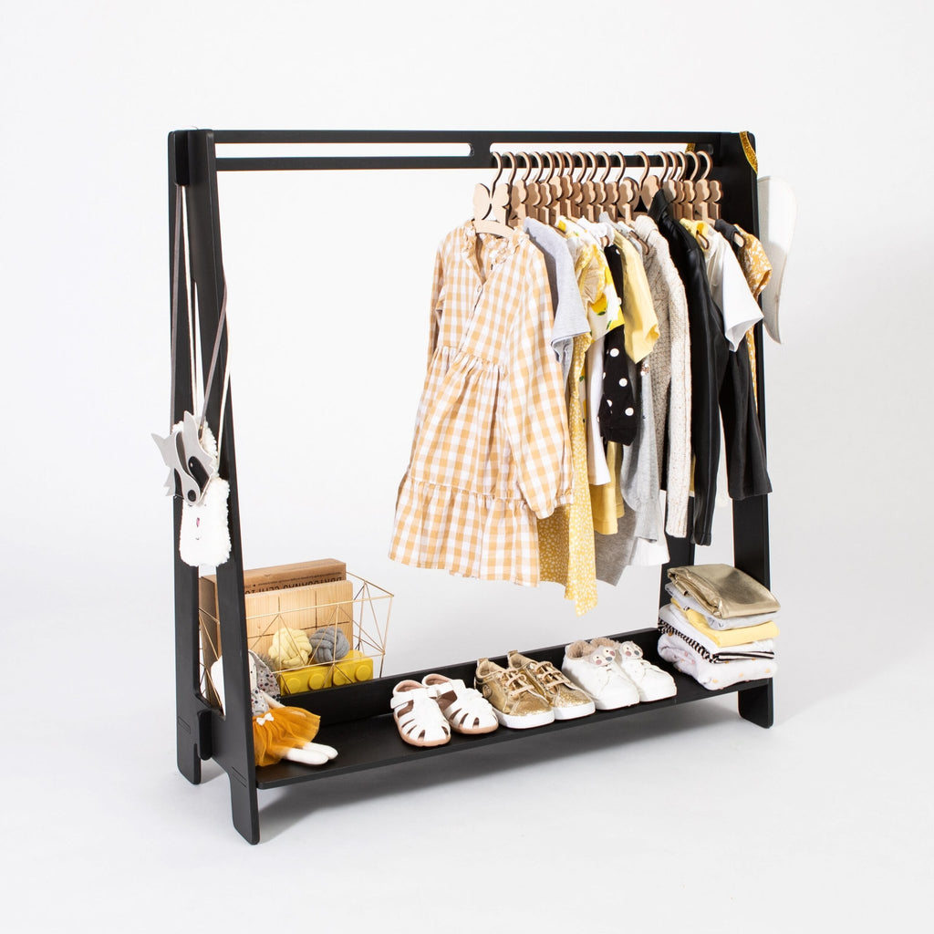 1. Black toddler clothing rack with hangers displaying various children's outfits and shoes on a white background