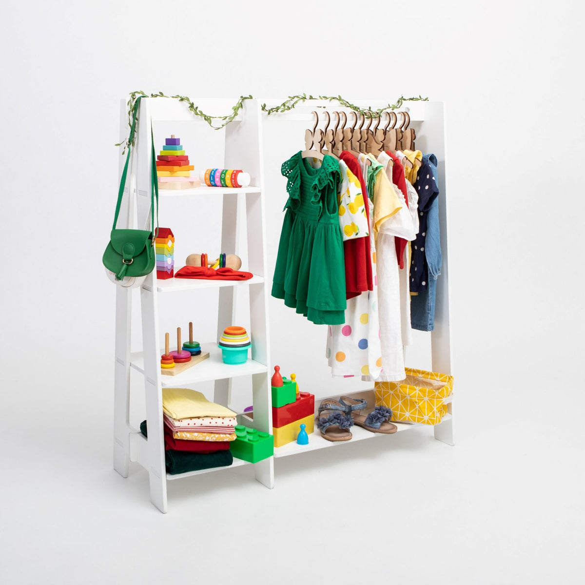 8. White clothing rack with colorful toddler clothes and toys on white background