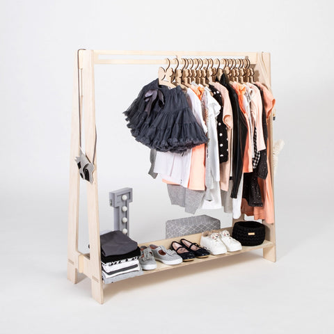3. Natural wood toddler clothing rack with pastel children's clothes and accessories on a white background