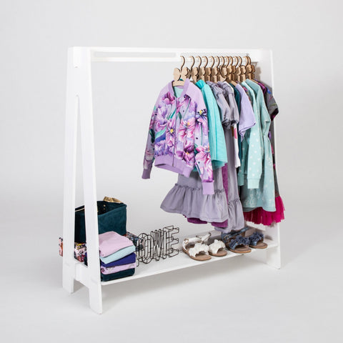 2. White toddler clothing rack with colorful children's clothes and shoes on a white background