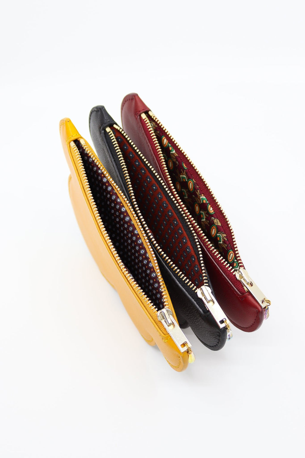 7. Trio of Tairi Roosve Leather Cloud Purses in black, yellow, and red, highlighting repurposed silk lining