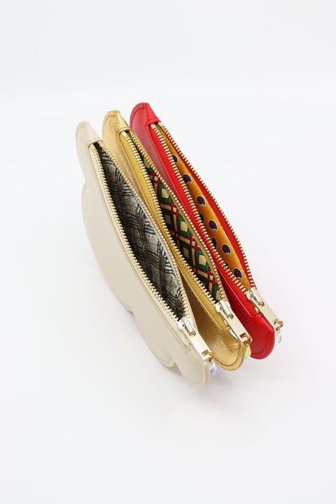 5. Close-up of Tairi Roosve cloud purses in red, gold, and cream, showing unique silk linings