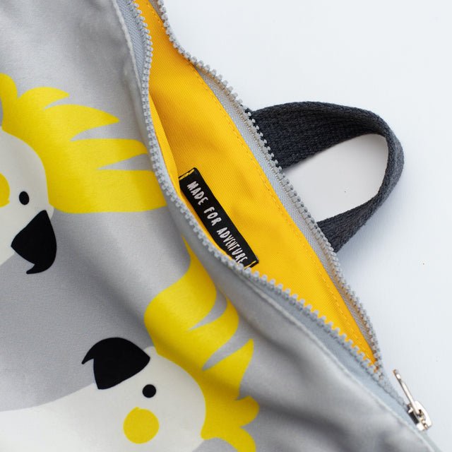 6. Interior view of Muni Cockatoo backpack, showing yellow lining and label