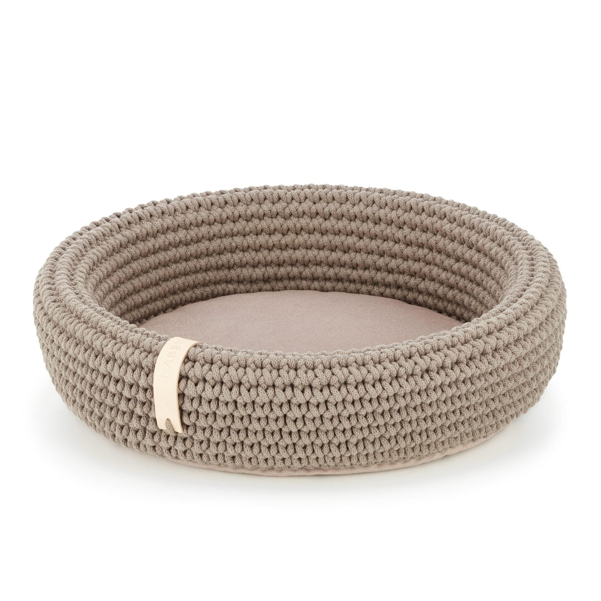 2. Light brown hand-woven pet bed made from Oeko-Tex cotton rope with soft pillow bottom, shown in studio setting